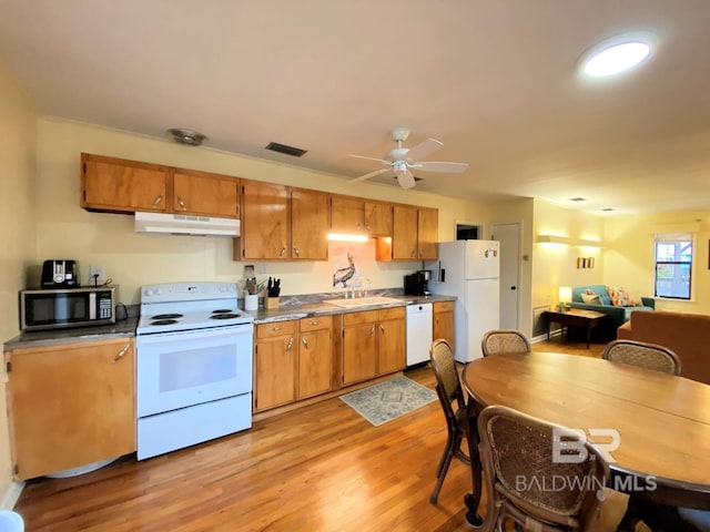 106 Ryan Ct, Dauphin Island, AL 36528 - kitchen with white appliances, a sink, light wood-style floors, and under cabinet range hood