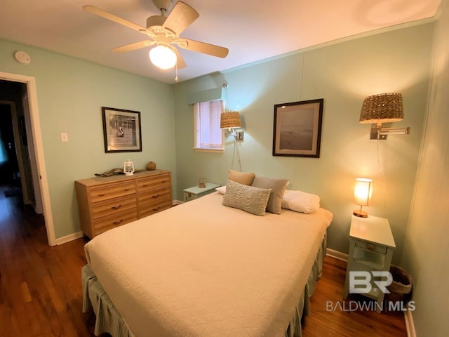 106 Ryan Ct, Dauphin Island, AL 36528 - bedroom featuring dark wood finished floors, baseboards, and a ceiling fan