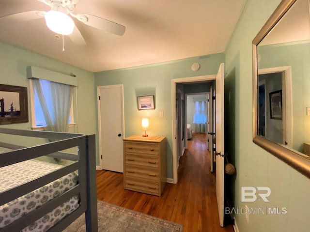 106 Ryan Ct, Dauphin Island, AL 36528 - bedroom featuring dark wood-style flooring, baseboards, and a ceiling fan