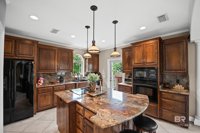 kitchen with black appliances, tasteful backsplash, light tile patterned flooring, a center island, and stone counters