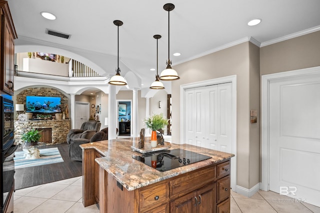 kitchen featuring ornate columns, black appliances, light tile patterned floors, pendant lighting, and recessed lighting