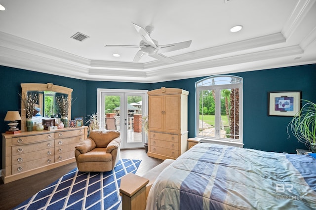 bedroom featuring a tray ceiling, multiple windows, access to outside, crown molding, and french doors