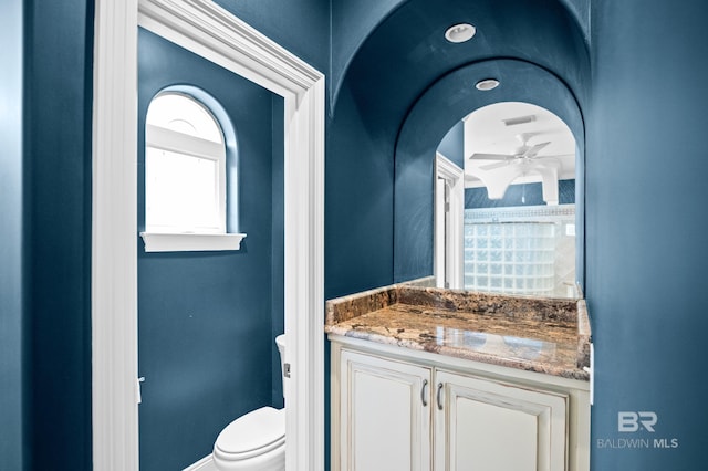 bathroom with toilet, a ceiling fan, and vanity