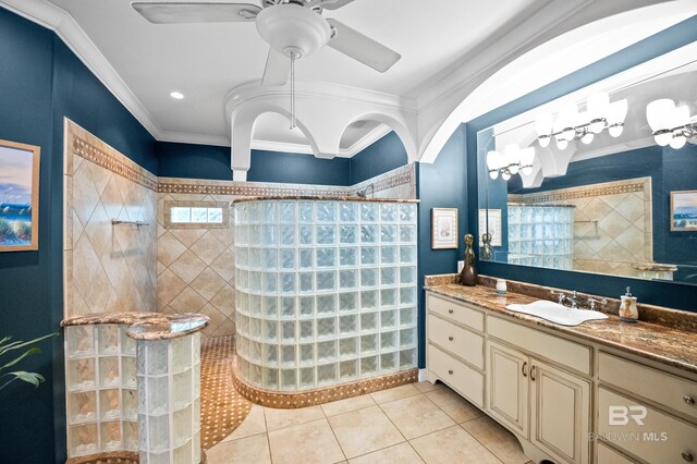 full bathroom featuring a walk in shower, tile patterned flooring, crown molding, vanity, and a ceiling fan