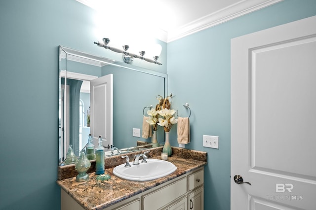 bathroom with crown molding and vanity