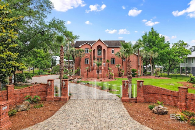 view of front of house featuring driveway and a gate