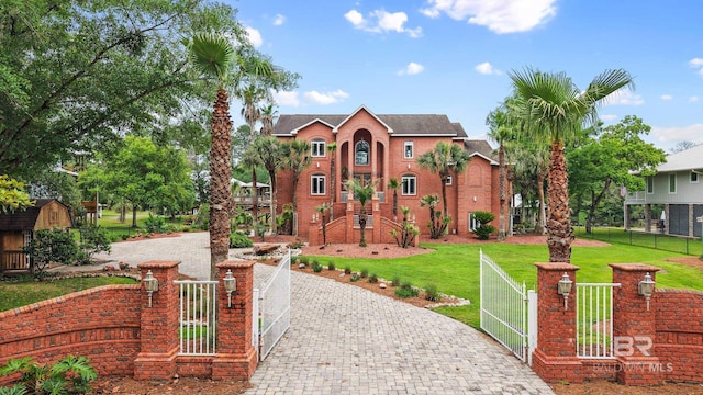 view of front facade with a gate and decorative driveway