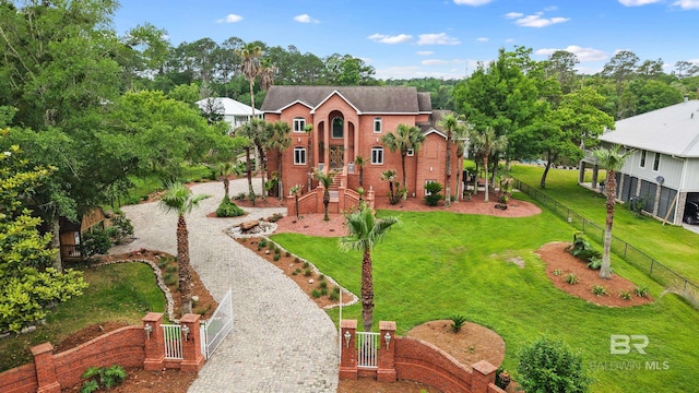 view of front of house with decorative driveway and a gate