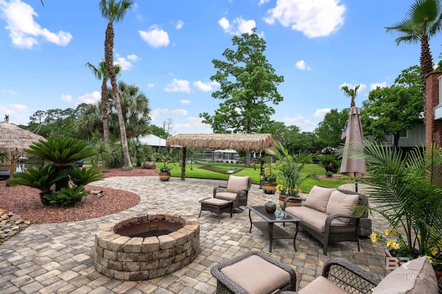 view of patio / terrace featuring a gazebo and an outdoor living space with a fire pit