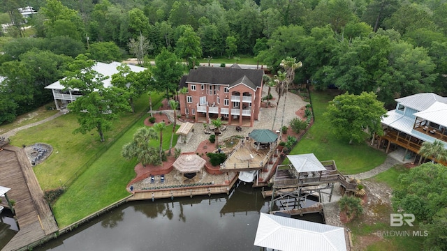 aerial view of property and surrounding area with a large body of water and a forest