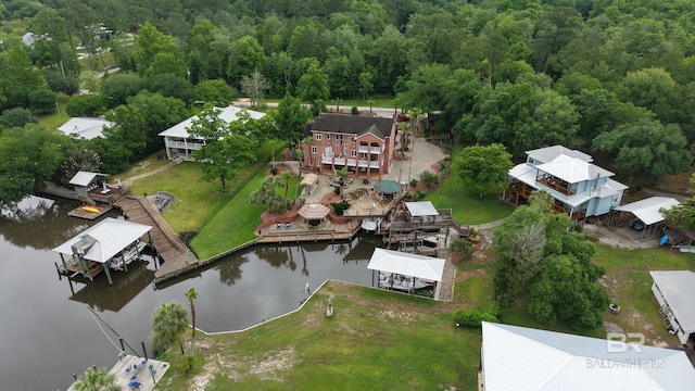 drone / aerial view of a nearby body of water and a forest
