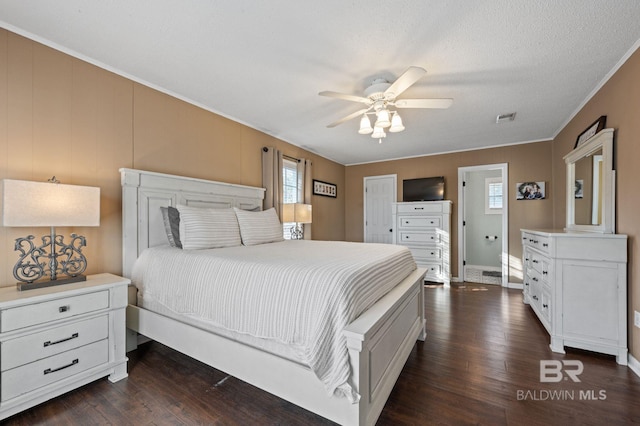 bedroom with crown molding, ceiling fan, dark hardwood / wood-style flooring, and a textured ceiling