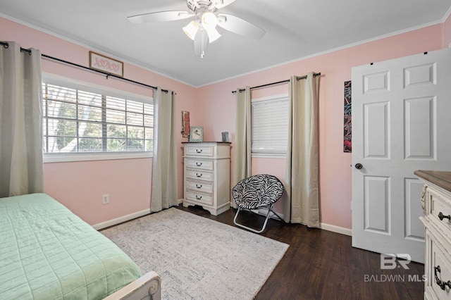 bedroom featuring dark wood-type flooring, ceiling fan, and ornamental molding