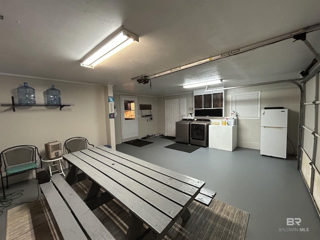 garage featuring washer and clothes dryer and white fridge