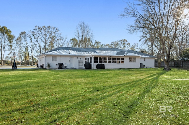 back of house featuring a lawn