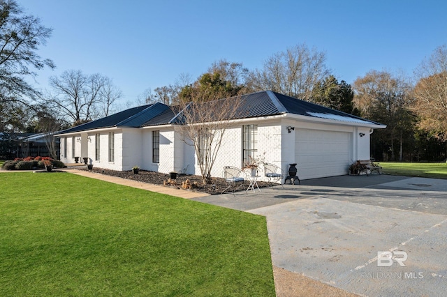 view of side of property featuring a garage and a yard