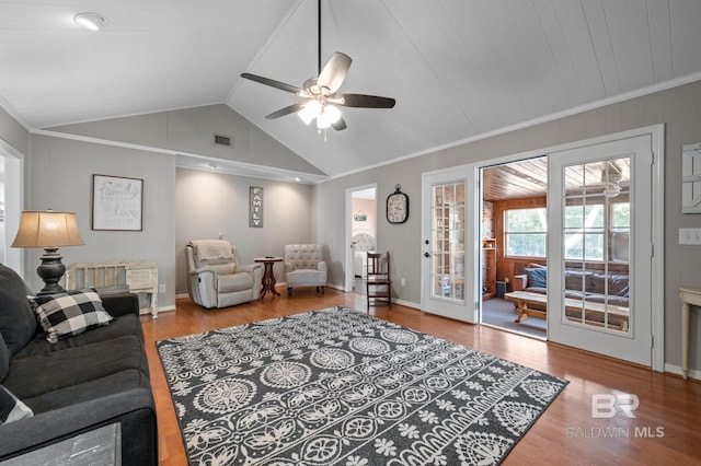 living room with crown molding, ceiling fan, wood-type flooring, and vaulted ceiling