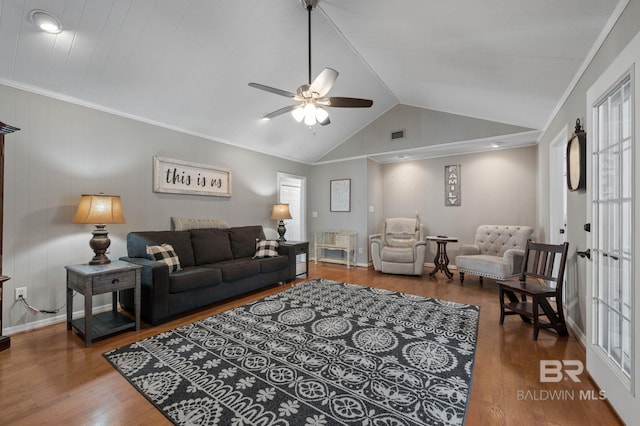 living room featuring wood-type flooring, lofted ceiling, ceiling fan, and crown molding