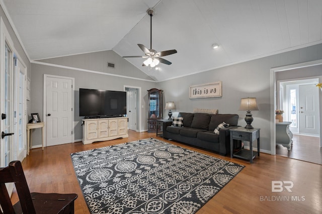 living room featuring hardwood / wood-style flooring, vaulted ceiling, and ceiling fan