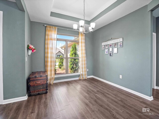 17163 Feder Dr, Foley, AL 36535 - unfurnished dining area with baseboards, dark wood-style flooring, a notable chandelier, and a raised ceiling