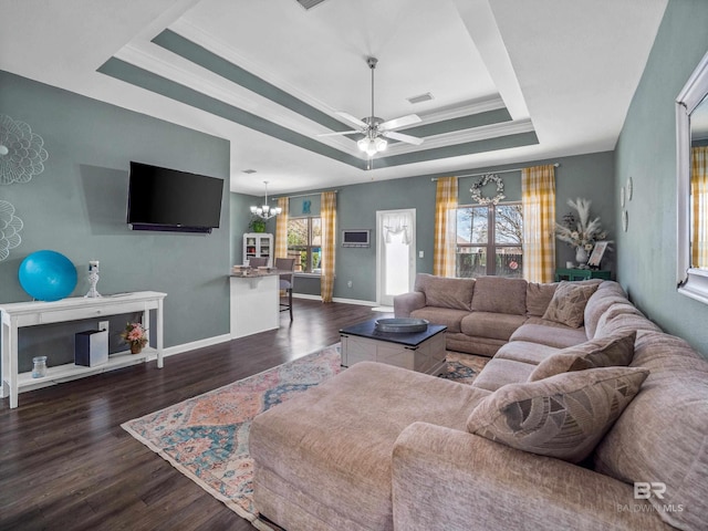 17163 Feder Dr, Foley, AL 36535 - living room featuring a raised ceiling, ceiling fan with notable chandelier, baseboards, ornamental molding, and dark wood-style flooring