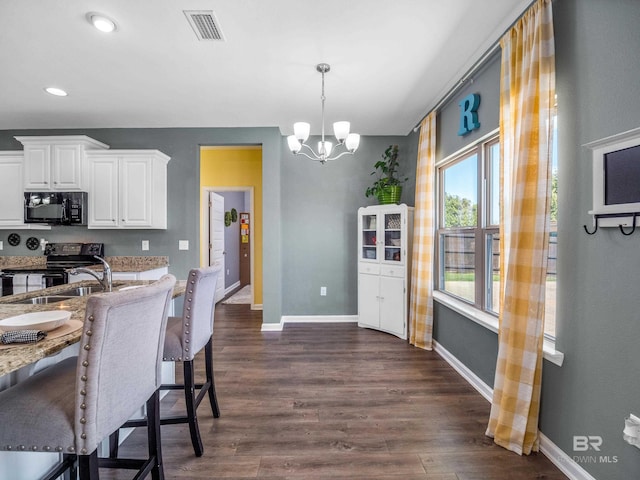 17163 Feder Dr, Foley, AL 36535 - kitchen featuring visible vents, black appliances, a notable chandelier, and dark wood finished floors