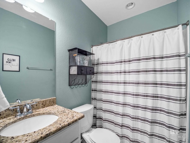 17163 Feder Dr, Foley, AL 36535 - bathroom with a textured wall, curtained shower, toilet, and vanity