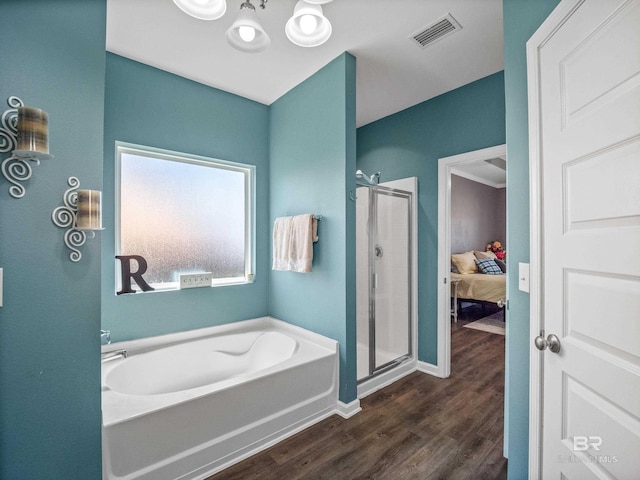 17163 Feder Dr, Foley, AL 36535 - ensuite bathroom featuring a bath, a shower stall, connected bathroom, visible vents, and wood finished floors