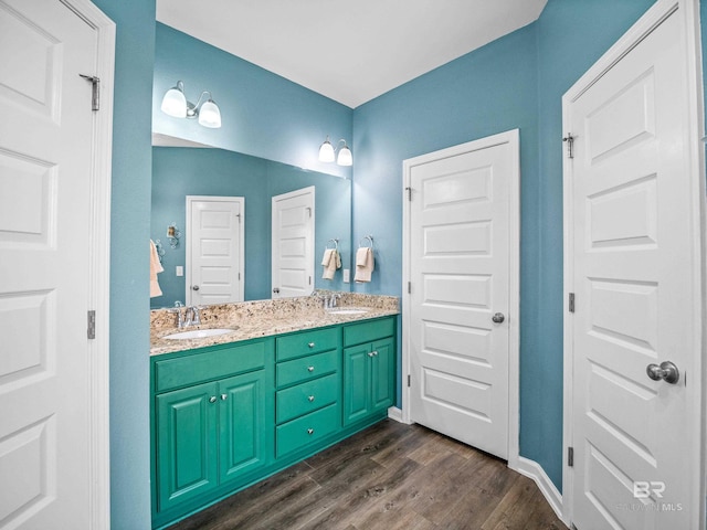 17163 Feder Dr, Foley, AL 36535 - full bathroom with double vanity, wood finished floors, baseboards, and a sink