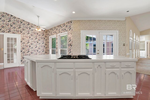 6805 Hunters Ct, Mobile, AL 36695 - kitchen featuring vaulted ceiling, french doors, wallpapered walls, black gas stovetop, and tile countertops