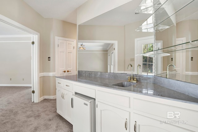 6805 Hunters Ct, Mobile, AL 36695 - kitchen featuring light carpet, a sink, white cabinetry, and baseboards