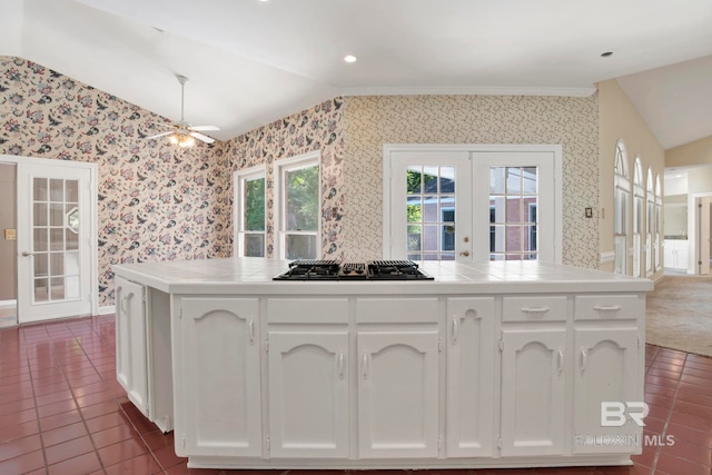 6805 Hunters Ct, Mobile, AL 36695 - kitchen with lofted ceiling, wallpapered walls, french doors, black gas cooktop, and tile counters