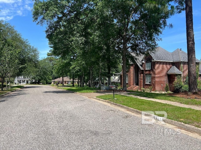 6805 Hunters Ct, Mobile, AL 36695 - view of asphalt road with curbs and sidewalks