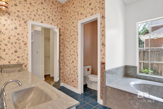 6805 Hunters Ct, Mobile, AL 36695 - full bathroom with wallpapered walls, tile patterned flooring, double vanity, a bath, and toilet
