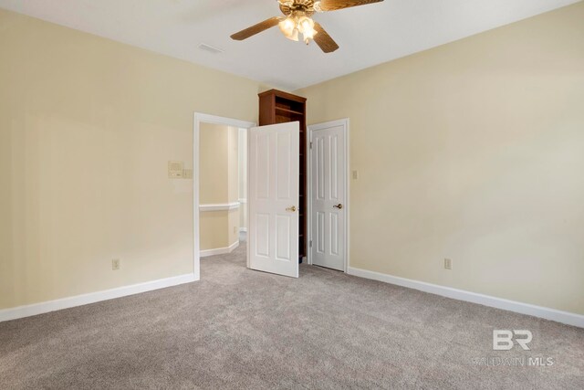6805 Hunters Ct, Mobile, AL 36695 - unfurnished bedroom featuring light carpet, baseboards, and a ceiling fan