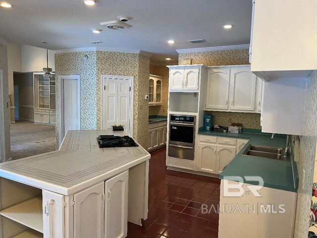 6805 Hunters Ct, Mobile, AL 36695 - kitchen featuring a warming drawer, stainless steel oven, crown molding, black gas stovetop, and a kitchen island
