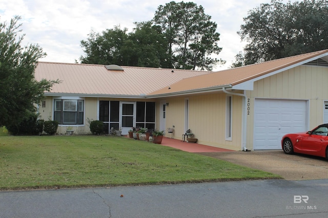 ranch-style house featuring a front yard and a garage