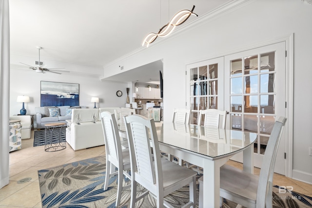 dining room with crown molding, tile patterned flooring, a ceiling fan, and french doors