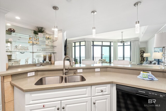 kitchen featuring crown molding, pendant lighting, open floor plan, a sink, and dishwasher