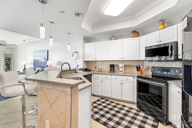kitchen with light tile patterned flooring, appliances with stainless steel finishes, a sink, a tray ceiling, and visible vents