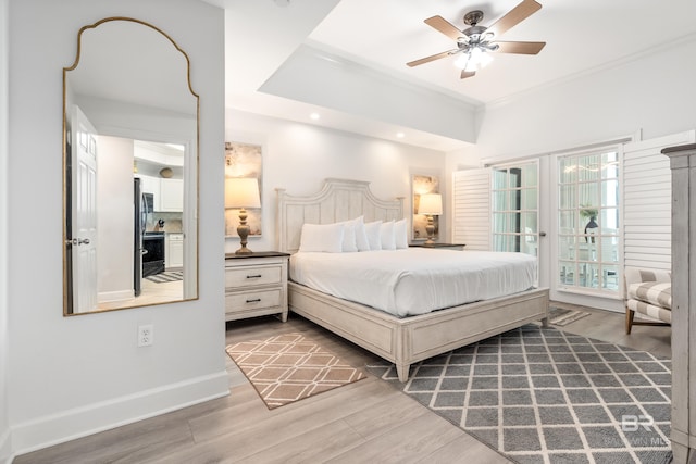 bedroom featuring crown molding, baseboards, wood finished floors, and access to exterior