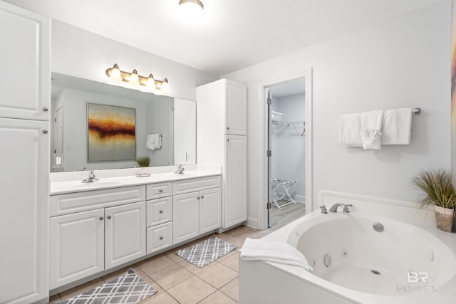 bathroom featuring double vanity, a sink, tile patterned floors, and a tub with jets