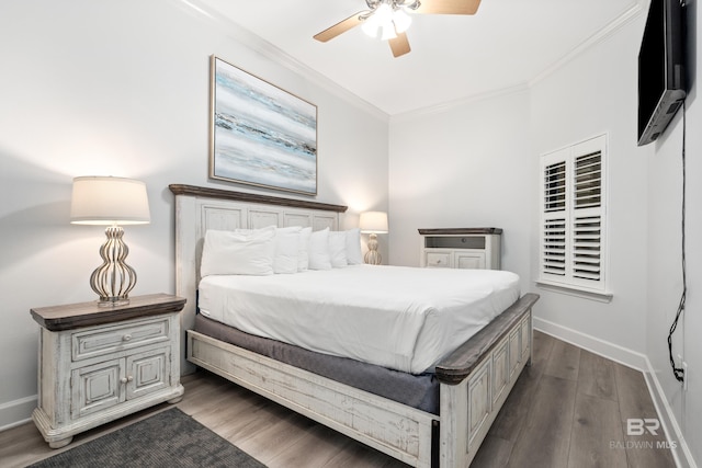 bedroom with crown molding, baseboards, and dark wood-style flooring