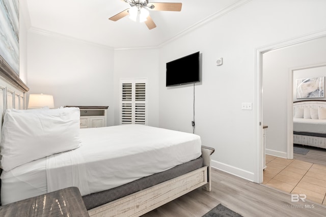 bedroom with baseboards, ornamental molding, light wood finished floors, and ceiling fan