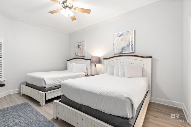 bedroom featuring ceiling fan, baseboards, ornamental molding, and wood finished floors
