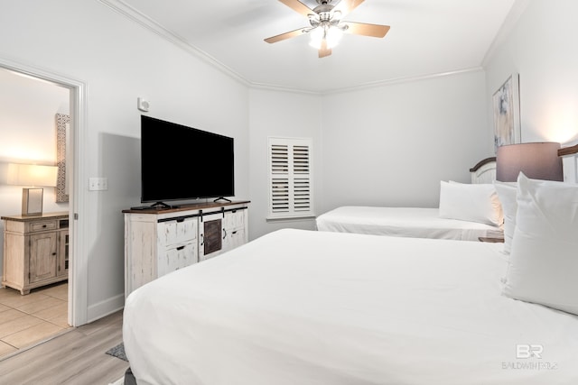 bedroom with ornamental molding, a ceiling fan, light wood-type flooring, and visible vents