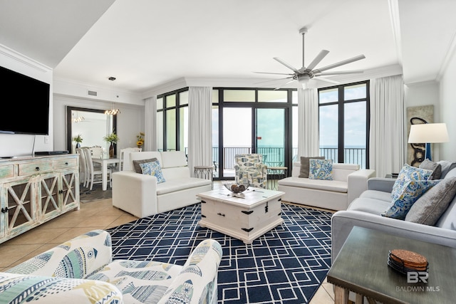 living area featuring crown molding, tile patterned floors, a ceiling fan, and visible vents