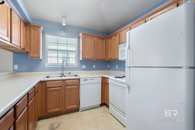 kitchen featuring white appliances and sink