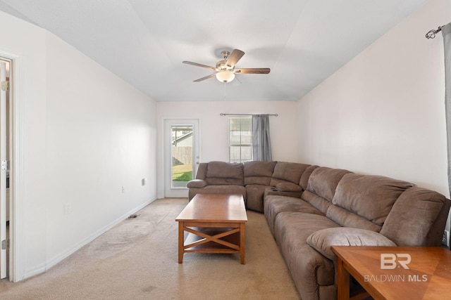 carpeted living room with ceiling fan