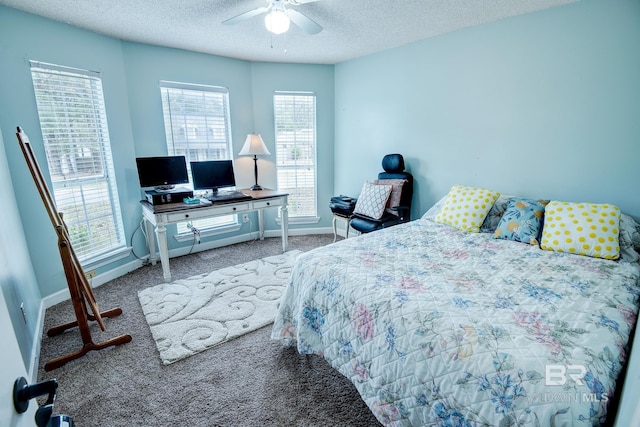 carpeted bedroom featuring multiple windows, a textured ceiling, and ceiling fan